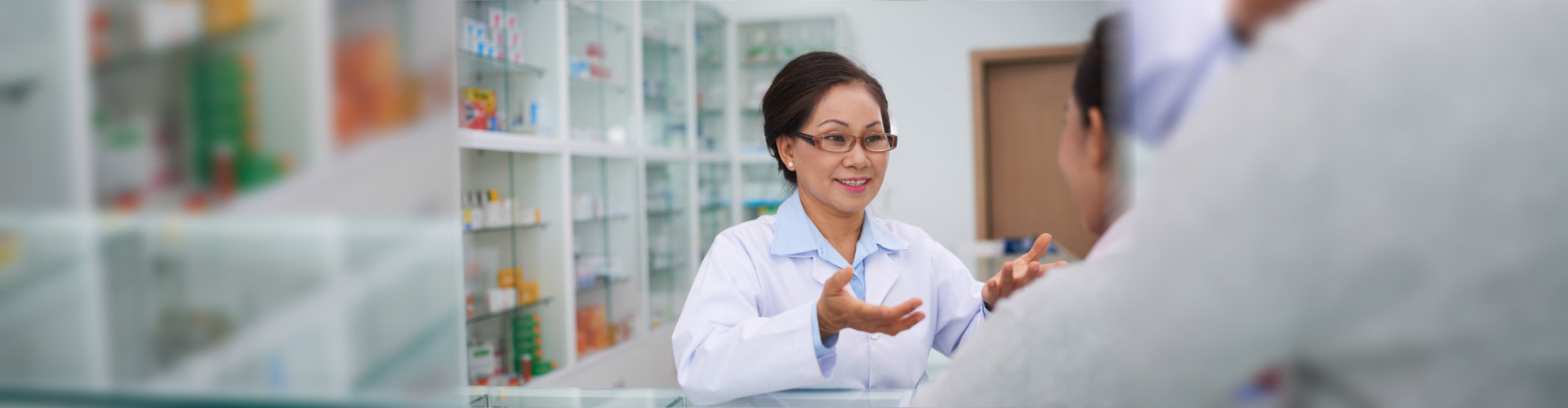Female pharmacist talking to drugstore customer